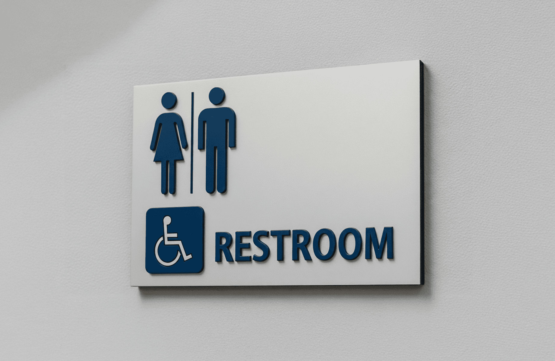 Wall-mounted restroom sign featuring raised blue symbols with dimensional lettering