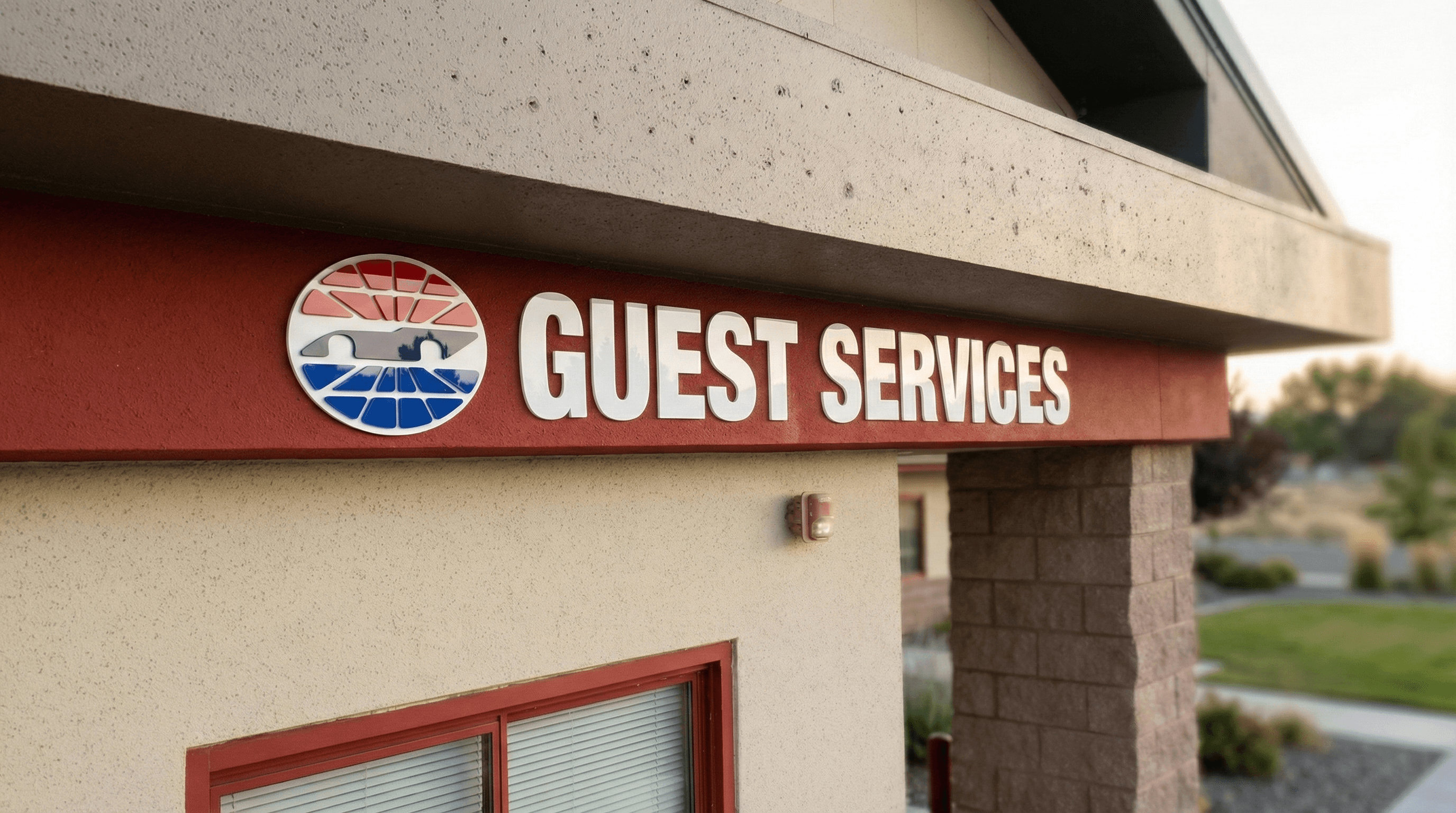 Large blue Guest Services wayfinding sign with directional arrow