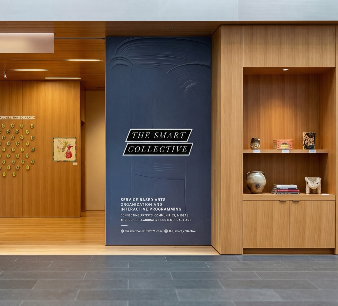 Tall blue Smart Collective branded graphic panel set between wood millwork