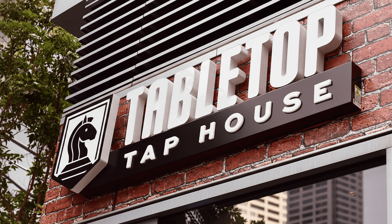Tabletop Tap House exterior pub sign with integrated shield logo on painted wood and metal