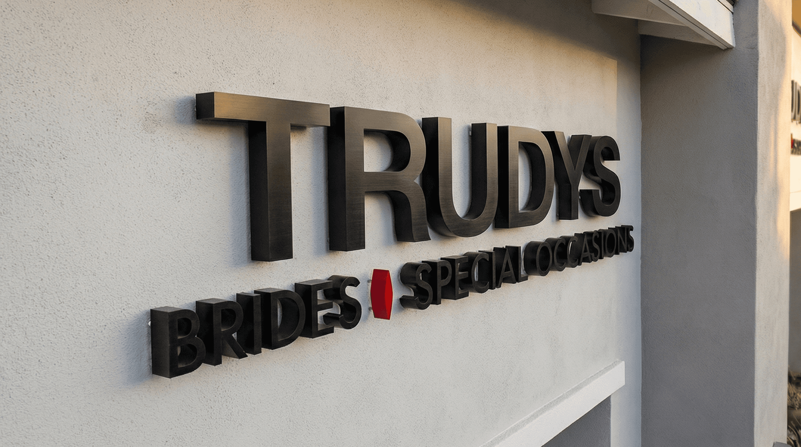 Trudy's Brides Special Occasions colorful dimensional storefront sign in San Jose